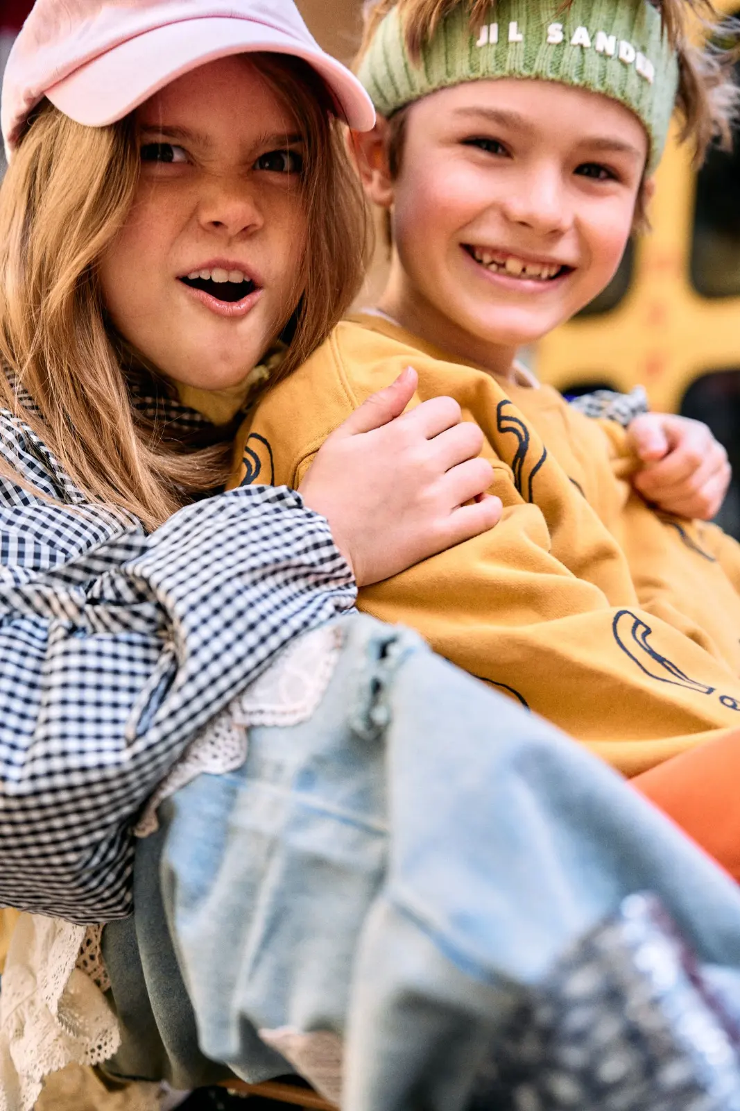 Kids in headbands hugging and smiling